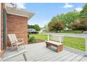 Relaxing front porch with seating, offering a peaceful view of the surrounding yard and neighborhood at 1280 Willowbreeze Sw Ct, Concord, NC 28025