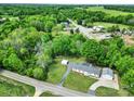 Aerial shot of a white home featuring a two-car garage, a carport, and a lush green yard at 1981 Line Rd, Lancaster, SC 29720