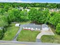 Overhead view of a property with a detached garage, carport, and lush green surroundings on a bright day at 1981 Line Rd, Lancaster, SC 29720