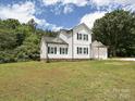 Beautiful two-story house with white siding, black shutters, and green lawn at 240 Doster Rd, Lancaster, SC 29720