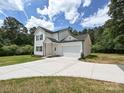 Attractive home with white siding, a large driveway, and an attached garage at 240 Doster Rd, Lancaster, SC 29720