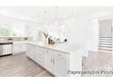 Spacious kitchen boasts a large island with seating, stainless steel appliances, and ample counter space, opening to living area at 2416 Morgan Hills Dr # 297P, Albemarle, NC 28001