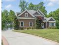 Desirable exterior of this lovely home with stone and wood, complemented by a long driveway at 2501 Mt Isle Harbor Dr, Charlotte, NC 28214