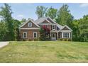 Charming exterior of this well-maintained home, featuring a lush green lawn and mature trees at 2501 Mt Isle Harbor Dr, Charlotte, NC 28214