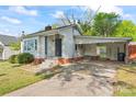 Single-story home with a brick foundation, covered parking, and small front yard at 288 Fink Nw Ave, Concord, NC 28025