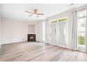 Bright living room with fireplace, modern flooring, and large windows showcasing natural light at 3906 Thomas Ridge Dr, Charlotte, NC 28269