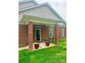 Inviting front porch with brick columns, perfect for relaxing outdoors at 4223 Willow View Ct, Matthews, NC 28105