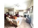 Spacious living room featuring a fireplace, ceiling fan, and laminate flooring at 4223 Willow View Ct, Matthews, NC 28105