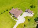 Aerial shot showcasing the home's layout, large yard, and detached garage on a sunny day at 514 Clover Leaf Rd, Marshville, NC 28103