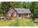 Beautiful brick home with a manicured front lawn and a welcoming front porch at 5283 Fieldstone Dr, Concord, NC 28025