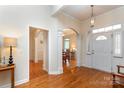 Bright foyer with hardwood floors, featuring an arched entrance and elegant lighting at 5283 Fieldstone Dr, Concord, NC 28025