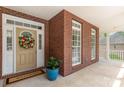 Charming front porch with brick facade and welcome mat, offering a warm greeting at 5283 Fieldstone Dr, Concord, NC 28025