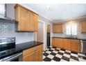 This updated kitchen showcases stainless steel appliances, custom cabinetry, and checkerboard floors at 539 Marsh Rd, Charlotte, NC 28209