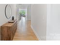 Bright hallway featuring wood floors that lead to the living area with natural light and stylish decor at 6145 Holland St, Fort Mill, SC 29707