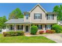 Charming two-story home featuring a welcoming front porch and beautiful landscaping at 6622 Cedar Cliff Dr, Charlotte, NC 28216