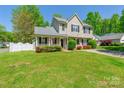 Charming two-story home featuring a welcoming front porch and beautiful landscaping at 6622 Cedar Cliff Dr, Charlotte, NC 28216