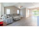 Spacious living room with vaulted ceilings, recessed lighting, and gray plank flooring at 6622 Cedar Cliff Dr, Charlotte, NC 28216