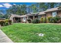 Well-maintained brick home with manicured landscaping, complemented by a bright green lawn at 704 Colby Cir, Salisbury, NC 28147