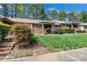 Inviting brick home with beautiful landscaping, green lawn, and walkway leading to the entrance at 704 Colby Cir, Salisbury, NC 28147