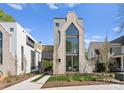 Striking modern home with architectural details, a three-story window feature, and manicured landscaping at 721 Charles Ave, Charlotte, NC 28205