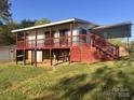 Two-story home with a covered deck and stairway on a sunny day at 7527 Old Shelby Rd, Vale, NC 28168