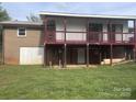 Two-story home featuring a covered deck with stairs leading to the yard at 7527 Old Shelby Rd, Vale, NC 28168