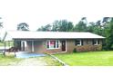 Single story brick house with metal roof, a covered parking area and well maintained lawn at 7527 Old Shelby Rd, Vale, NC 28168