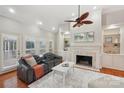 Bright living room with a fireplace, custom built-ins, hardwood floors, and a comfortable sofa at 7626 Vistaview Dr, Cornelius, NC 28031