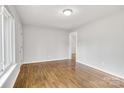 An open living room is adorned with light gray walls and beautiful, gleaming hardwood floors at 801 Bilmark Ave, Charlotte, NC 28213