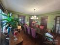 Charming dining room featuring beautiful hardwood floors and a stylish chandelier at 829 Green St, Salisbury, NC 28144