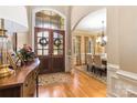 Inviting foyer with hardwood floors, arched doorways, and a view into the formal dining room at 9200 Kingsmead Ln, Waxhaw, NC 28173