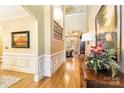 Grand foyer with hardwood floors, wainscoting, and a view of the staircase and living spaces at 9200 Kingsmead Ln, Waxhaw, NC 28173