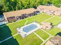 Stunning aerial view of the community pool surrounded by lush green lawns and well-maintained apartment buildings at 103 Carriage House Dr, Kannapolis, NC 28081