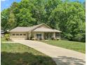 Well-maintained single-story home with long driveway and a screened-in porch perfect for relaxing outdoors at 10340 Williams Rd, Mint Hill, NC 28227