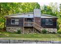 A charming house with a stone foundation and wooden siding, offering a cozy and inviting curb appeal at 1042 Jackson Rd, Fort Lawn, SC 29714
