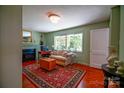 Cozy living room with fireplace, hardwood floors, and bright natural light from the windows at 1081 Deas St, Rock Hill, SC 29732