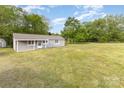 A quaint, single-story home situated on a vast, well-manicured lawn with mature trees at 1119 Highway 218 W Hwy, Indian Trail, NC 28079