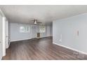 Spacious living room with vinyl wood flooring, painted walls, and a ceiling fan at 1119 Highway 218 W Hwy, Indian Trail, NC 28079