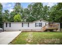 Charming home featuring an inviting entryway, well-maintained lawn, and a welcoming front deck at 114 Oakland Rd, Belmont, NC 28012