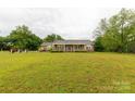 Lovely brick home with a well maintained lawn and mature trees at 1162 E Doc Garris Rd, Lancaster, SC 29720