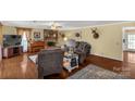 Inviting living room with brick fireplace, hardwood floors, and plenty of seating at 1162 E Doc Garris Rd, Lancaster, SC 29720