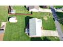Aerial view of a property showcasing a well-maintained lawn, a shed, and surrounding neighborhood streets at 123 Cross Creek Dr, Statesville, NC 28625