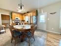 Bright eat-in kitchen featuring classic oak cabinets, stainless steel appliances, and a rustic dining set at 123 Cross Creek Dr, Statesville, NC 28625