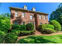 Charming brick home with dormers, manicured hedges, and a well-maintained lawn at 1233 Weymouth Ln, Charlotte, NC 28270