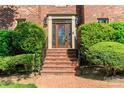 Elegant brick front steps leading to a beautiful wood and glass paneled front door at 1233 Weymouth Ln, Charlotte, NC 28270