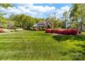 Beautiful brick home with manicured lawn and lush landscaping at 17040 Jetton Rd, Cornelius, NC 28031