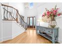 Bright foyer with hardwood floors, staircase, and decorative table at 17040 Jetton Rd, Cornelius, NC 28031