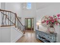 Bright foyer with soaring ceilings, hardwood floors, grand staircase and stylish decor offers a welcoming ambiance at 17040 Jetton Rd, Cornelius, NC 28031
