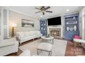 Cozy living room features a stone fireplace with built-in shelving, a plush sofa, and stylish decor for relaxation at 1713 Mt Isle Harbor Dr, Charlotte, NC 28214