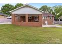 A covered porch overlooks the expansive, well-maintained backyard at 182 Ryan St, Salisbury, NC 28144